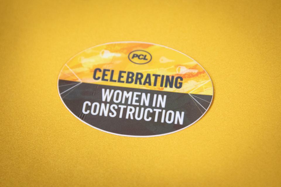 A sticker celebrating women in construction rests on a booth table for PLC Construction during the Coastal Bend Women in Industry Conference on Thursday, April 11, 2024, in Robstown, Texas. The Canadian company builds refineries and furnaces.