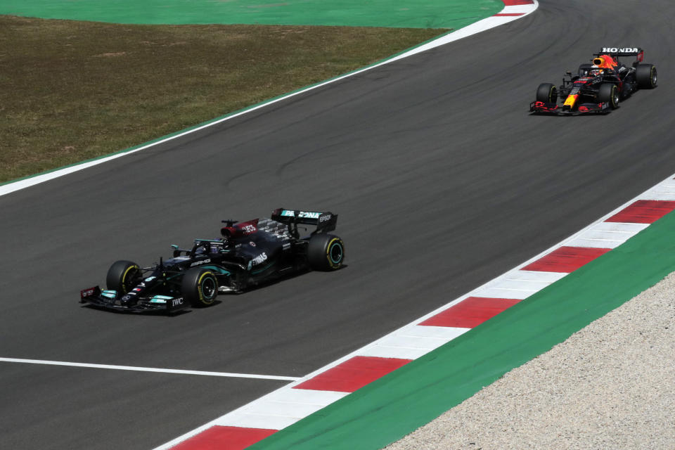 Mercedes driver Lewis Hamilton of Britain steers his car followed by Red Bull driver Max Verstappen of the Netherlands, right, during the Portugal Formula One Grand Prix at the Algarve International Circuit near Portimao, Portugal, Sunday, May 2, 2021. (AP Photo/Manu Fernandez)