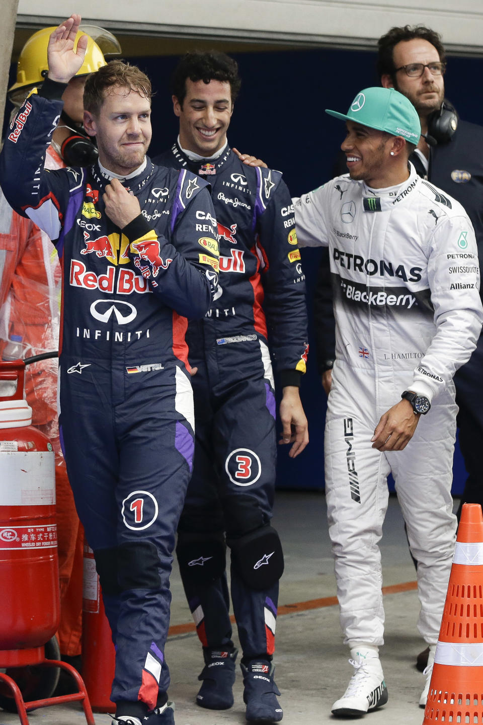 From left to right, Red Bull Racing driver Sebastian Vettel of Germany, Red Bull Racing driver Daniel Ricciardo of Australia, and Mercedes driver Lewis Hamilton of Britain walk together after the qualifying session of the Chinese Formula One Grand Prix at Shanghai International Circuit in Shanghai, Saturday, April 19, 2014. (AP Photo/Alexander F. Yuan)