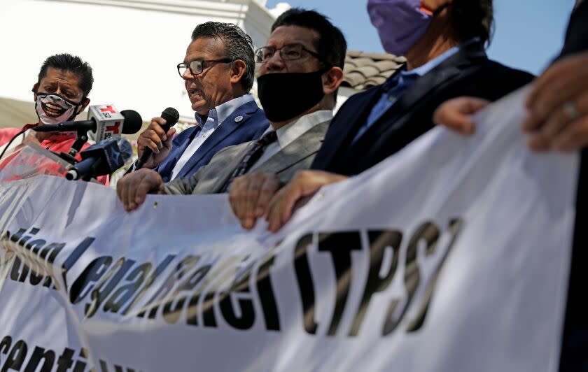 LOS ANGELES-CA-JUNE 11, 2020: Pro immigrant rights leaders including Francisco Moreno, General Coordinator for Mexican Migrants Abroad, second from left, speaks at a news conference to call on President Donald Trump to extend temporary protected status to workers in the country without legal permission who were deemed by him to be essential workers during the coronavirus pandemic, at Placita Olvera in Los Angeles, California on Thursday, June 11, 2020. (Christina House / Los Angeles Times)