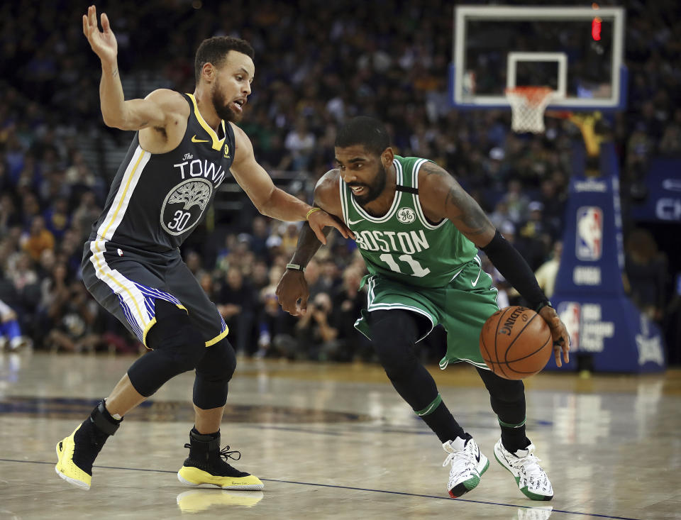 Boston Celtics’ Kyrie Irving, right, drives the ball against Golden State Warriors’ Stephen Curry duringing the second half of an NBA basketball game Saturday, Jan. 27, 2018, in Oakland, Calif. (AP Photo/Ben Margot)