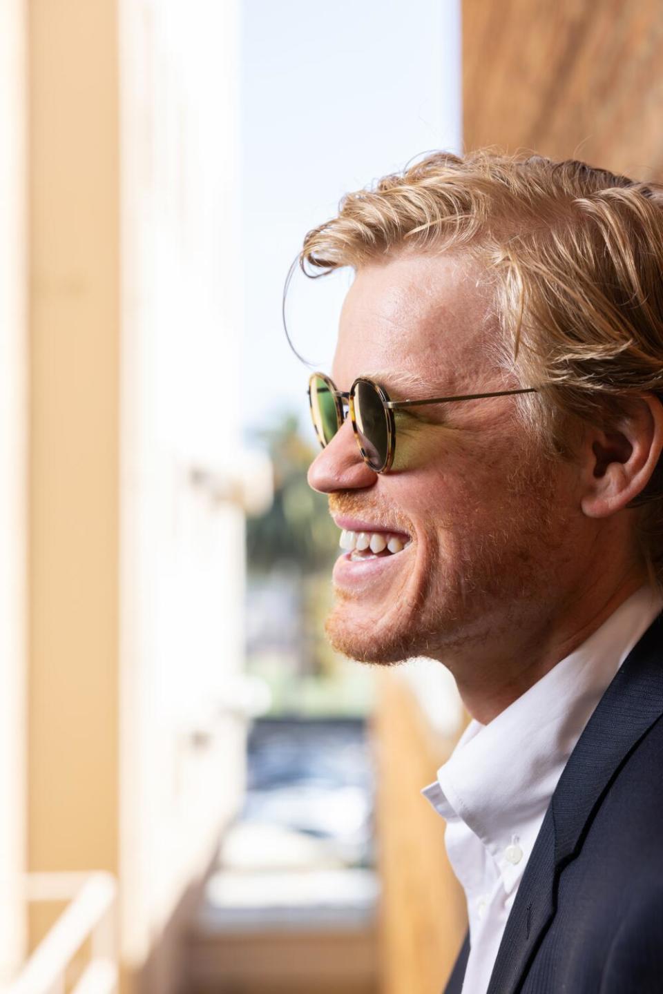 Jesse Plemons in sunglasses, smiling wide.