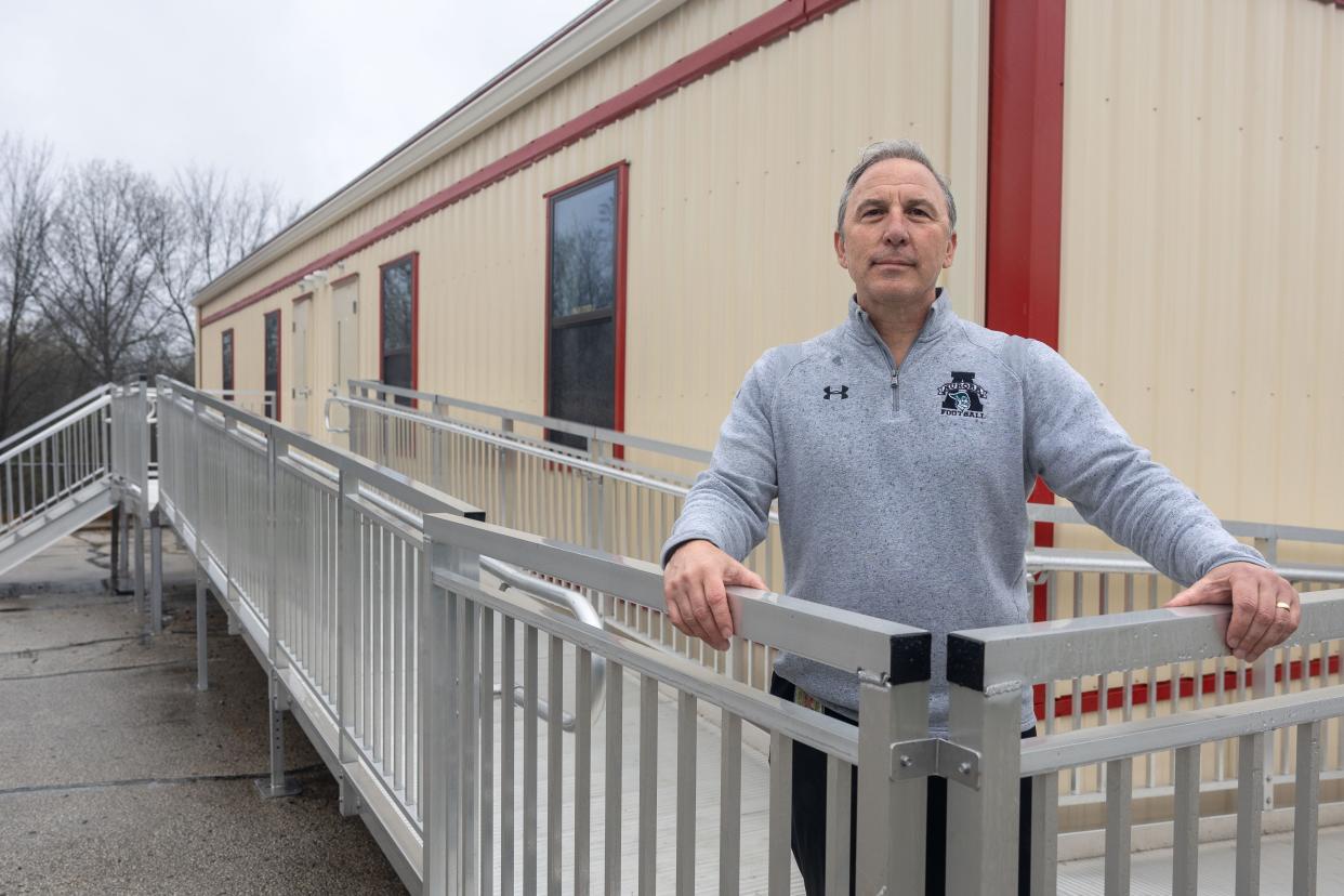 Aurora City Schools superintendent Mike Roberto stands outside a trailer that now serves as the Miller Elementary School’s library and music room. The original library and music room had to be converted to classroom space as the school district’s enrollment has grown.