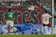 Mexico's goalkeeper Guillermo Ochoa saves a penalty kick by Poland's Robert Lewandowski during the World Cup group C soccer match between Mexico and Poland, at the Stadium 974 in Doha, Qatar, Tuesday, Nov. 22, 2022. (AP Photo/Themba Hadebe)