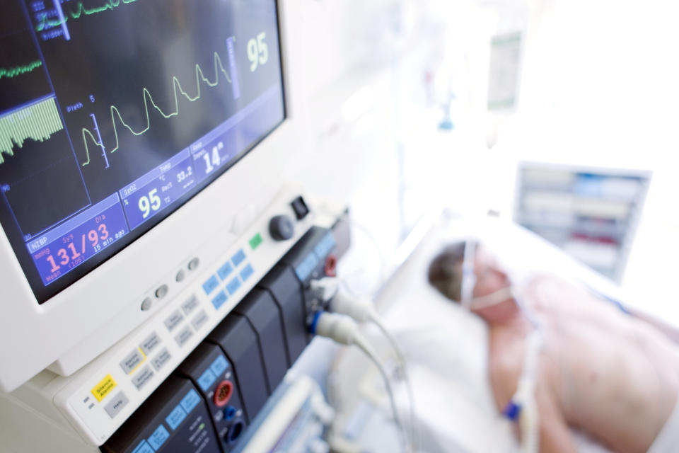 A patient in bed with his monitor in the foreground