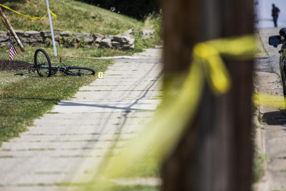 A bike is marked as evidence at the scene of a shooting on June 30, 2016 in Grand Rapids, Mich. In one of the worst periods of violence in 2020 for the city, 11 people were shot across the weekend of Sept. 12 and 13. Grand Rapids police responded by placing over 100 officers on the streets the following weekend, during which they collected 10 illegal weapons and made 16 felony arrests.<span class="copyright">Allison Farrand—Grand Rapids Press/AP</span>