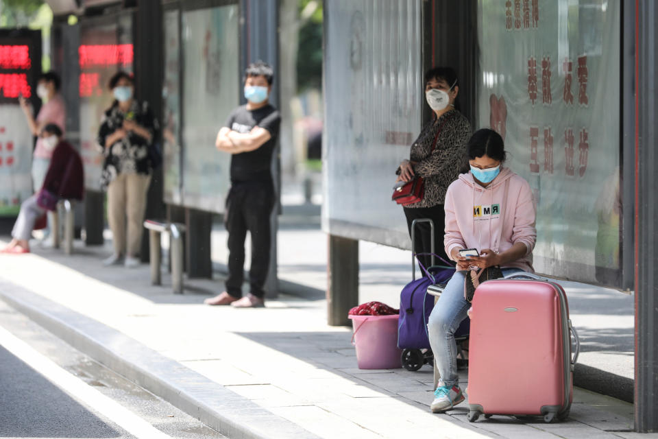 People wait at a bus station in Wuhan in China's central Hubei province on May 11, 2020. - China reported a second day of new cases of coronavirus in Wuhan on May 11 after a month without new infections at the pandemic's global epicentre, offering a stark warning of the dangers of a fresh wave. (Photo by STR / AFP) / China OUT (Photo by STR/AFP via Getty Images)