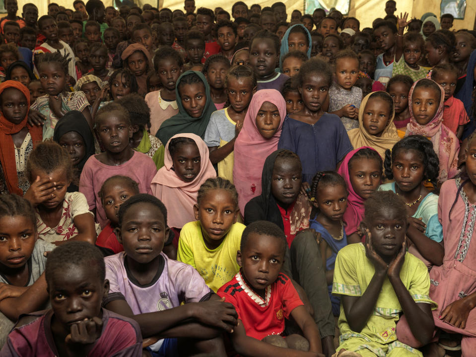 A crowd of children at the Renk refugee camp staring at the camera.