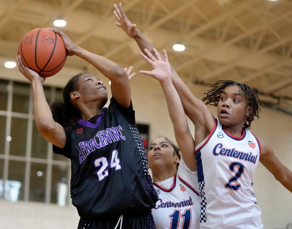 Africentric's Kamryn Grant goes up for a shot against Centennial's Chloe Perkins (11) and Kennedy Houston (2) during the City League championship game Saturday at East.