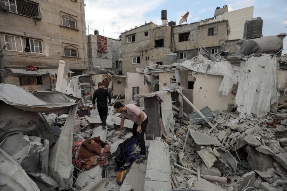 People search through buildings, destroyed during Israeli airstrikes a day earlier, in the southern Gaza Strip on Nov. 14, 2023 in Khan Yunis, Gaza.