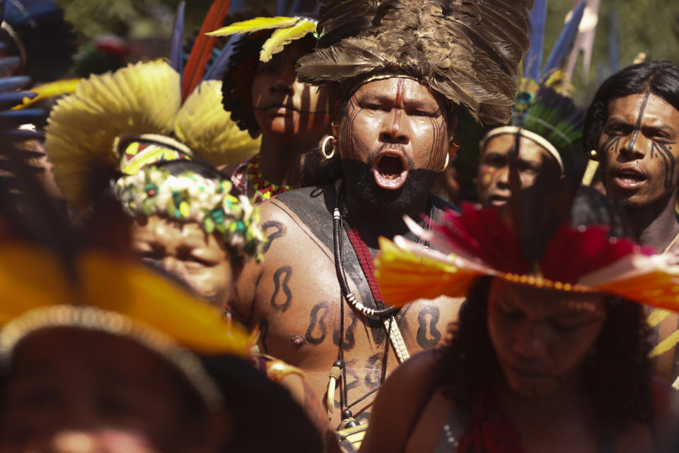 Indigenous people dance during the 20th annual Free Land Indigenous Camp in Brasilia, Brazil, Monday, April 22, 2024. The 7-day event aims to show the unity of Brazil's Indigenous peoples in their fight for the demarcation of their lands and their rights. (AP Photo/Luis Nova)