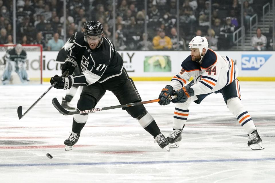 Kings forward Anze Kopitar, left, controls the puck in front of Edmonton Oilers forward Zack Kassian.