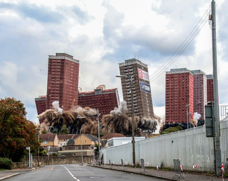 <p>The red road flats in Glasgow begin to crumble to the ground in a planned explosion. (Lesley Smith)</p>