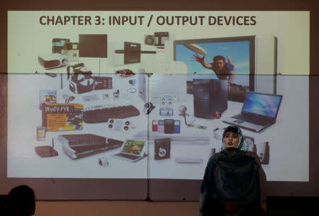 A teacher speaks to students during a computer studies class at the Islamabad College for girls in Islamabad, Pakistan, October 13, 2017. REUTERS/Caren Firouz