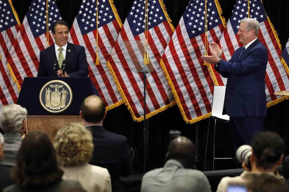 New York Gov. Andrew Cuomo, left, is applauded by former Vice President Al Gore as he makes an announcement about the environment where the governor signed the Climate Leadership and Community Protection Act, Thursday, July 18, 2019, at Fordham University in New York. New York’s new law aimed at ending climate change emissions will drive dramatic changes over the next 30 years if it meets its ambitious goals. (AP Photo/Richard Drew)