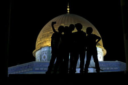 Palestinian Ali Souwan, 12, from the West Bank city of Hebron, takes a selfie photo with his friends in front of the Dome of the Rock on the compound known to Muslims as Noble Sanctuary and to Jews as Temple Mount, in Jerusalem's Old City, during the holy month of Ramadan, July 4, 2015. REUTERS/Ammar Awad