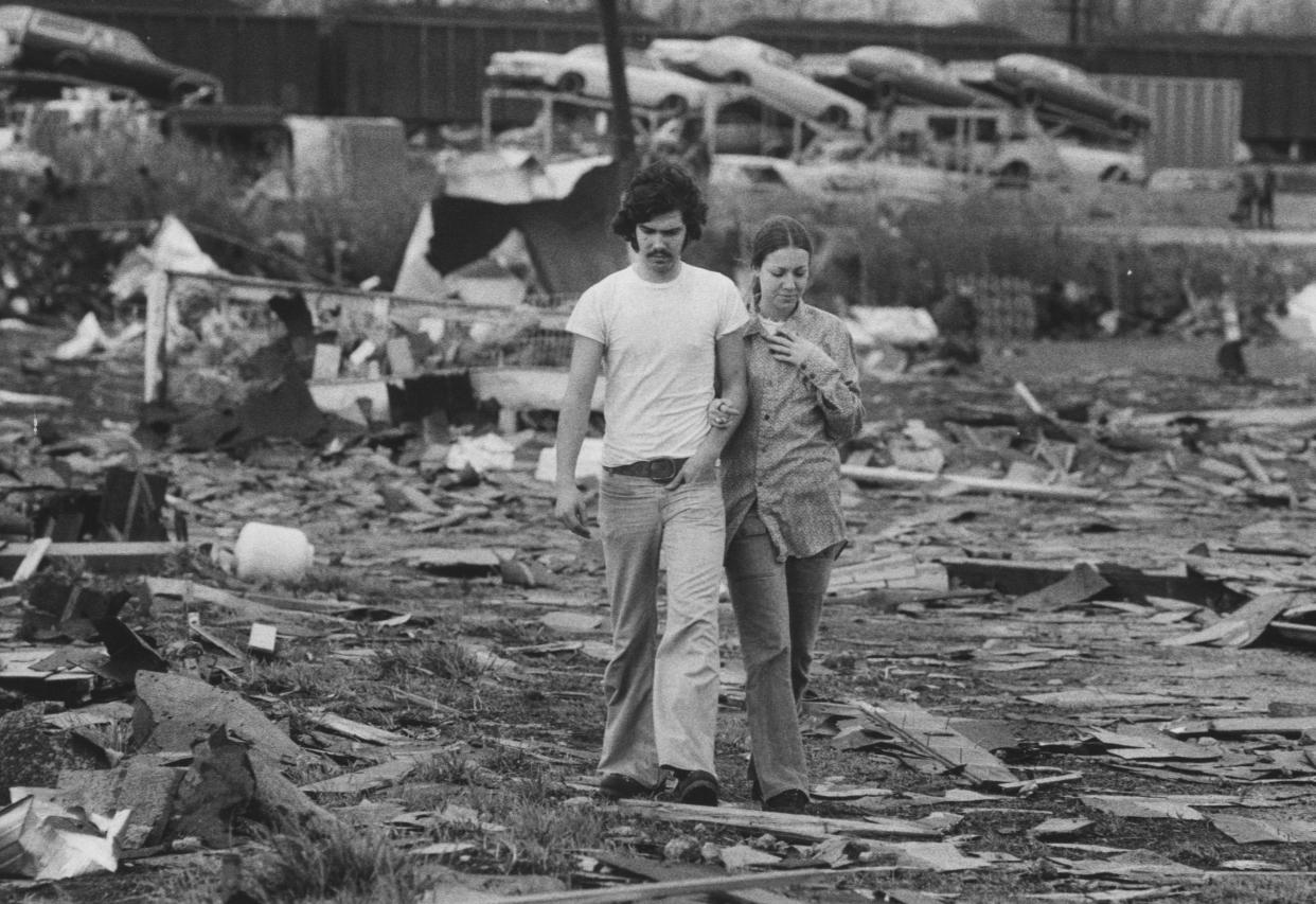 Kevin Jones and Becky Hampton survey the tornado damage near the fairgrounds.  April 3, 1974  