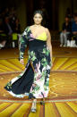 <p>A curvy model walks Christian Siriano’s runway wearing an asymmetrical floral, high-slit dress during New York Fashion Week. (Photo: Getty Images) </p>