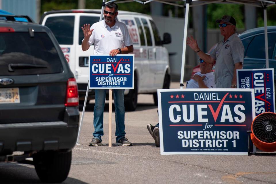 Dan Cuevas, a candidate for District Supervisor 1 in Harrison County, waves to voters arriving at a polling location at D’Iberville Civic Center in D’Iberville during the Mississippi Primary Election on Tuesday, Aug. 8, 2023.
