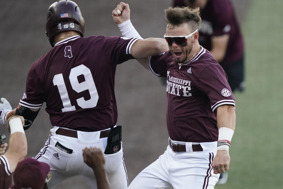 Mississippi State's Logan Tanner (19) celebrates with teammate Tanner Allen after hitting a second-inning three-run home run against Notre Dame during an NCAA college baseball super regional game, Monday, June 14, 2021, in Starkville, Miss. (AP Photo/Rogelio V. Solis)