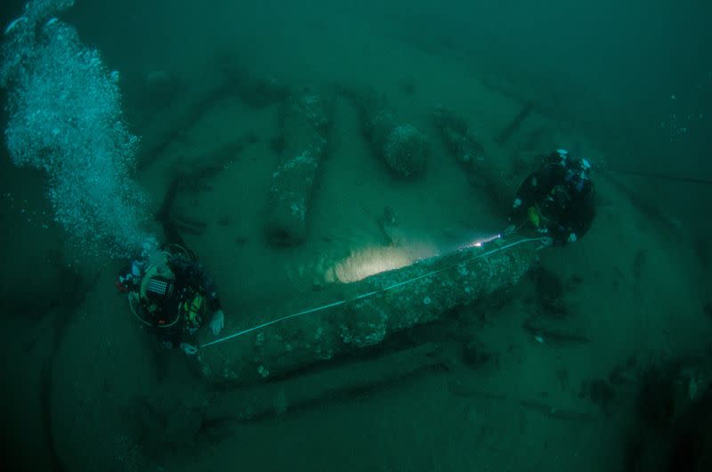 Brothers Julian Barnwell and Lincoln Barnwell measure a cannon underwater from the shipwreck of The Gloucester discovered off the coast of Norfolk