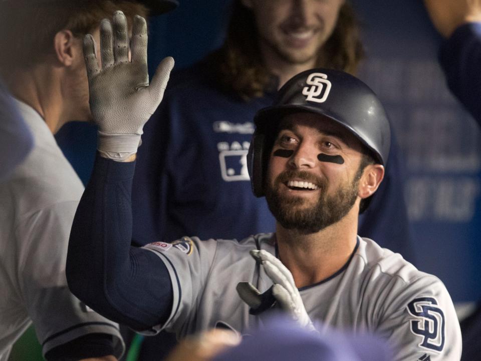 San Diego Padres' Greg Garcia celebrates in the dugout after he hit a home run against the Toronto Blue Jays during the fifth inning of a baseball game Friday, May 24, 2019, in Toronto. (Fred Thornhill/The Canadian Press via AP)