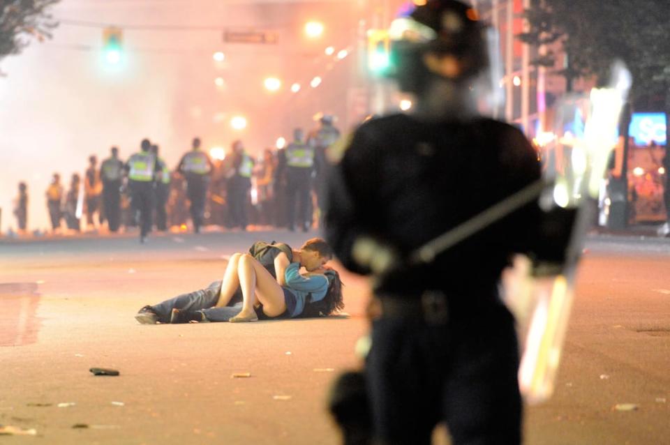 <div class="inline-image__caption"><p>Riot police walk in the street as a couple kiss on June 15, 2011 in Vancouver, Canada. Vancouver broke out in riots after their hockey team the Vancouver Canucks lost in Game Seven of the Stanley Cup Finals.</p></div> <div class="inline-image__credit">Rich Lam/Getty</div>