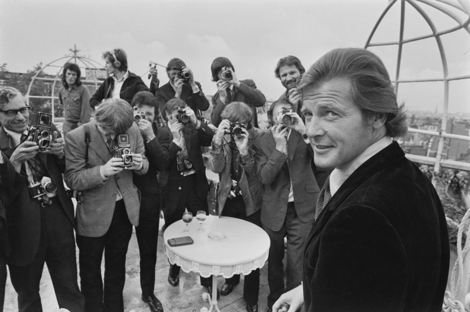 British actor Roger Moore (1927-2017) stands before a group of photographers at the announcement that 'Live and Let Die' would be the next Bond film, the first to star Moore in the title role, at The Dorchester Hotel in London, England, 2nd August 1972. (Photo by Jack Kay/Daily Express/Hulton Archive/Getty Images)