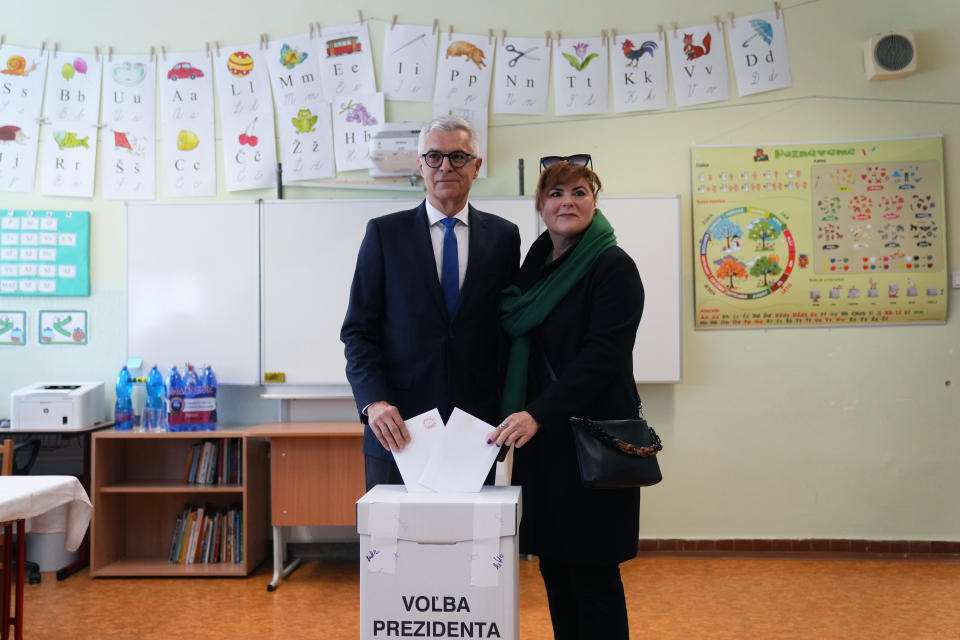 FILE - Presidential candidate Ivan Korcok and his wife Sona cast their votes during the first round of the presidential election in Senec, Slovakia, Saturday, March 23, 2024. Korcok, a pro-western career diplomat and Peter Pellegrini, a close ally of Slovakia's populist Prime Minister Robert Fico, are facing each other in a presidential runoff on Saturday, April 6, 2024, to determine who succeeds Zuzana Caputova, the country's first female head of state. (AP Photo/Petr David Josek, File)