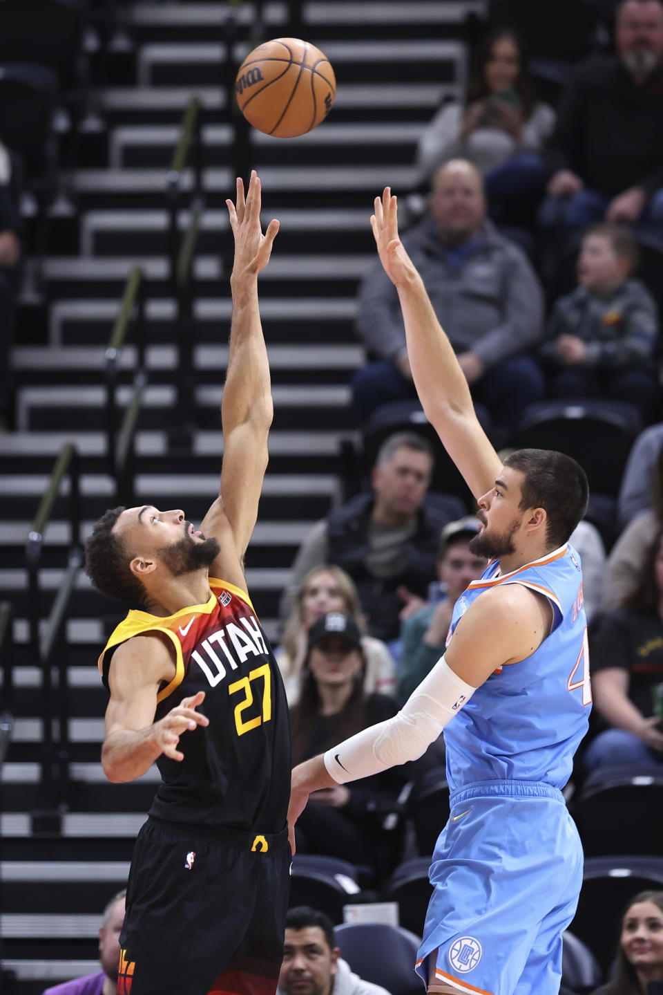 Los Angeles Clippers center Ivica Zubac (40) shoots over Utah Jazz center Rudy Gobert (27) during the first half of an NBA basketball game Friday, March 18, 2022, in Salt Lake City. (AP Photo/Rob Gray)