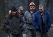 Workers involved in the rescue operation walk back to their vehicles in Donetsk on March 4, 2015