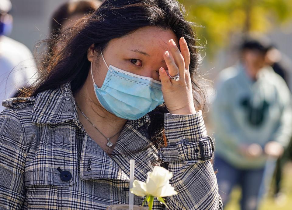 Esther Song tears up as she attends a community rally to raise awareness about anti-Asian violence and racist attitudes, in response to the string of violent racist attacks against Asians during the pandemic, held at Los Angeles Historic Park near the Chinatown district in Los Angeles, Saturday, Feb. 20, 2021.