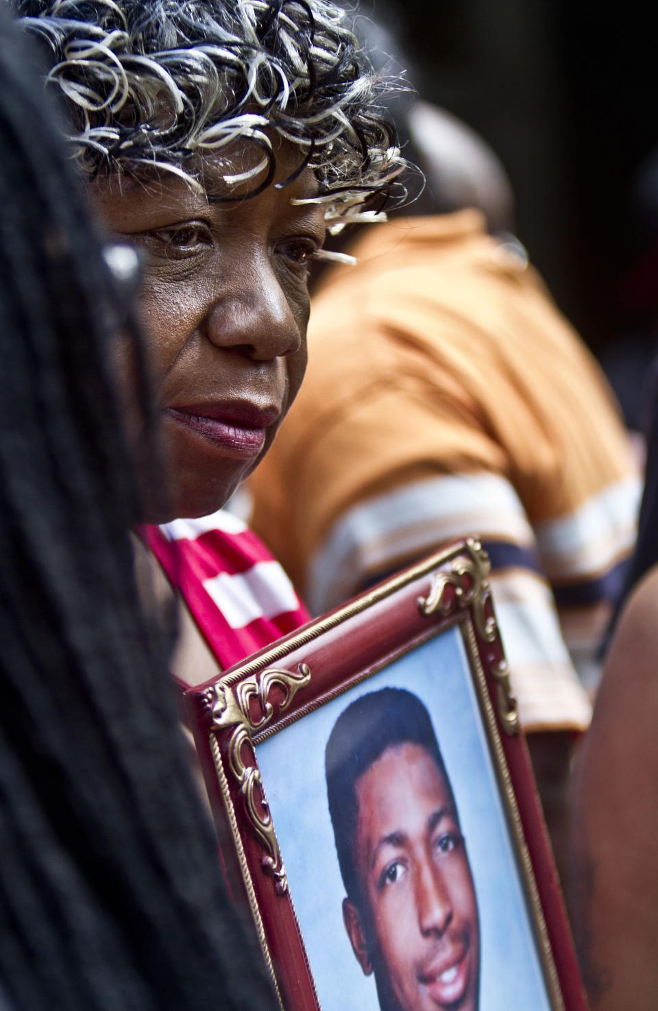 FILE - In this July 7, 2015, file photo, Gwen Carr holds a picture of her son Eric Garner during a news conference in New York with relatives of New Yorkers killed by police. Garner died in 2014 after being placed into a chokehold by an officer trying to arrest him for allegedly settling untaxed cigarettes. The city paid his family $5.9 million. On Thursday, April 6, 2017, New York City settled a $4 million wrongful arrest lawsuit brought by NBA player Thabo Sefolosha. City police broke his leg during the 2015 arrest causing him to miss the NBA Playoffs. Several unarmed men shot to death by New York City police received less money. (AP Photo/Bebeto Matthews, File)