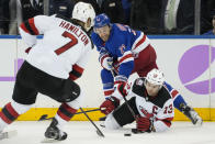 New Jersey Devils center Nico Hischier (13) and New York Rangers center Barclay Goodrow (21) battle for the puck in the second period of an NHL hockey game, Monday, Nov. 28, 2022, in New York. (AP Photo/John Minchillo)