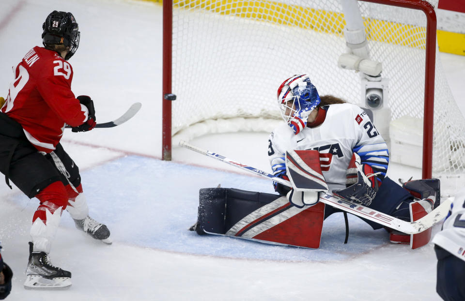 A shot by Canada's Marie-Philip Poulin, left, hits the post as U.S. goalie Nicole Hensley looks back during the third period of the IIHF hockey women's world championships title game in Calgary, Alberta, Tuesday, Aug. 31, 2021. (Jeff McIntosh/The Canadian Press via AP)