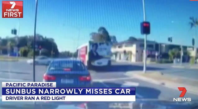The bus narrowly misses the white car on the left. Source: 7 News