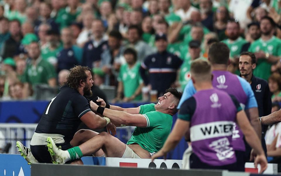 Scotland's loosehead prop Pierre Schoeman (L) tussles with Ireland's hooker Dan Sheehan