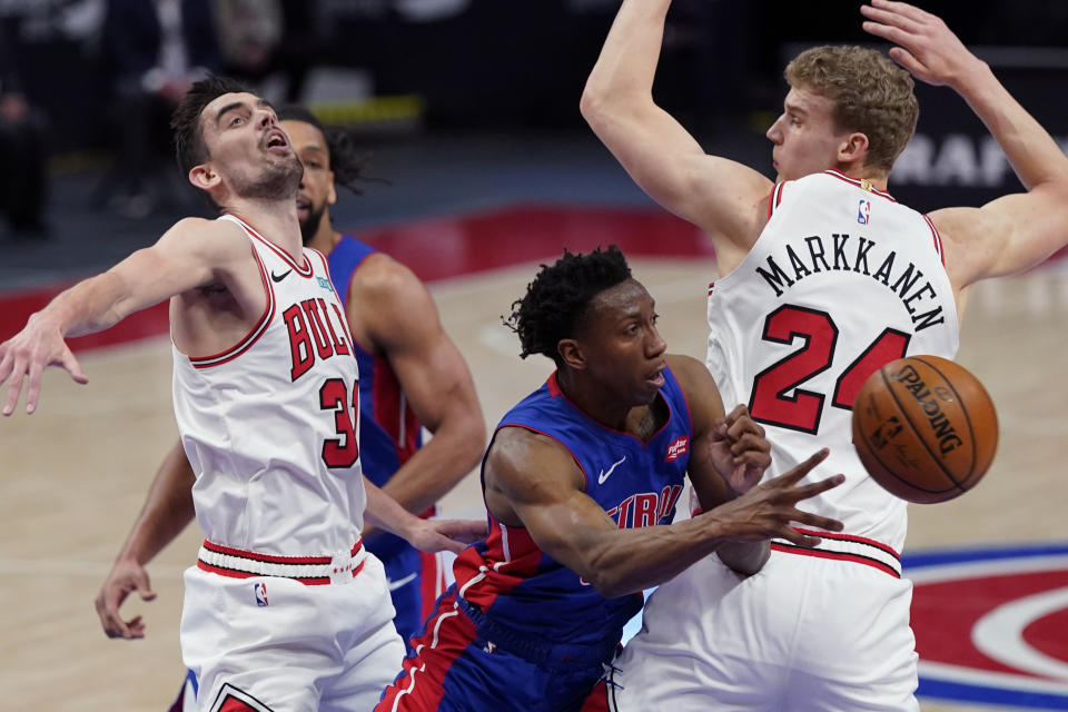 Detroit Pistons guard Saben Lee passes as Chicago Bulls guard Tomas Satoransky (31) and forward Lauri Markkanen (24) defend during the first half of an NBA basketball game, Sunday, May 9, 2021, in Detroit. (AP Photo/Carlos Osorio)