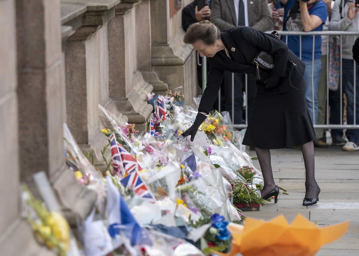 The Princess Royal looks at floral tributes during a visit to Glasgow City Chambers (John Linton/PA) (PA Wire)
