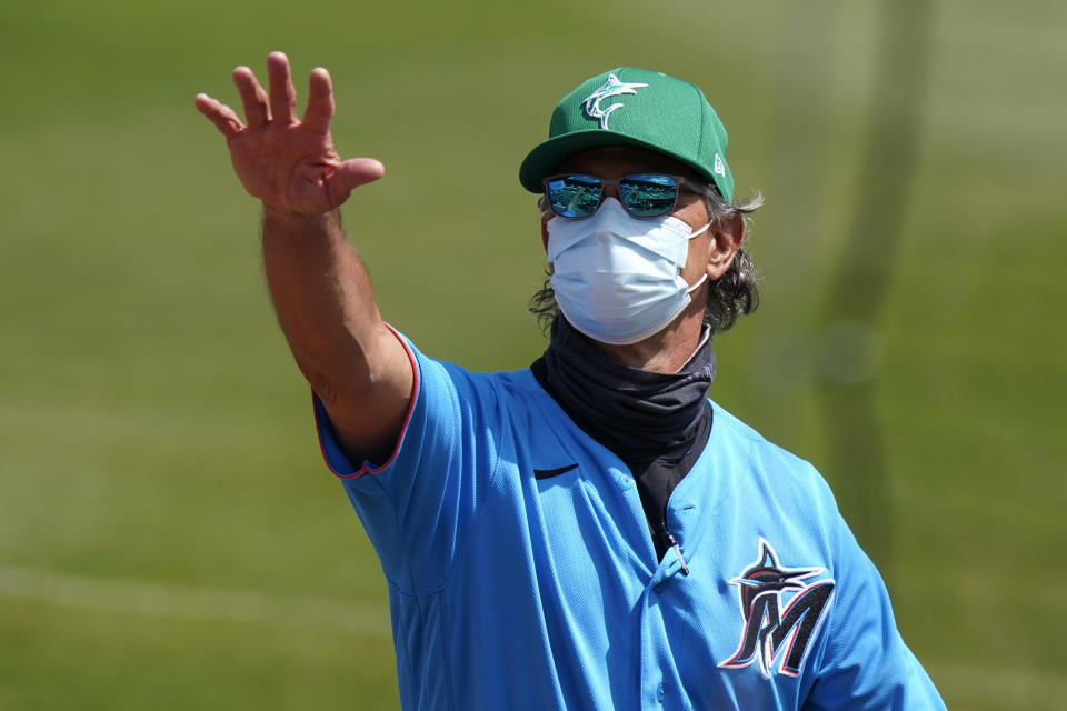 Miami Marlins manager Don Mattingly waves to the stands before a spring training baseball game against the New York Mets, Wednesday, March 17, 2021, in Jupiter, Fla. The former New York Yankees' American League batting champion knows his place now is in the dugout. As manager of the Miami Marlins, Don Mattingly finds it easy to resist any temptation to step to the plate and show his pitchers who he is — or was. (AP Photo/Lynne Sladky)