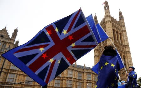 Anti-Brexit protesters wave EU and Union flags outside the Houses of Parliament in London, Britain, November 14, 2017. REUTERS/Peter Nicholls