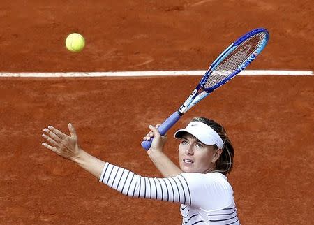 Maria Sharapova of Russia plays a shot to Kaia Kanepi of Estonia during their women's singles match at the French Open tennis tournament at the Roland Garros stadium in Paris, France, May 25, 2015. REUTERS/Jean-Paul Pelissier