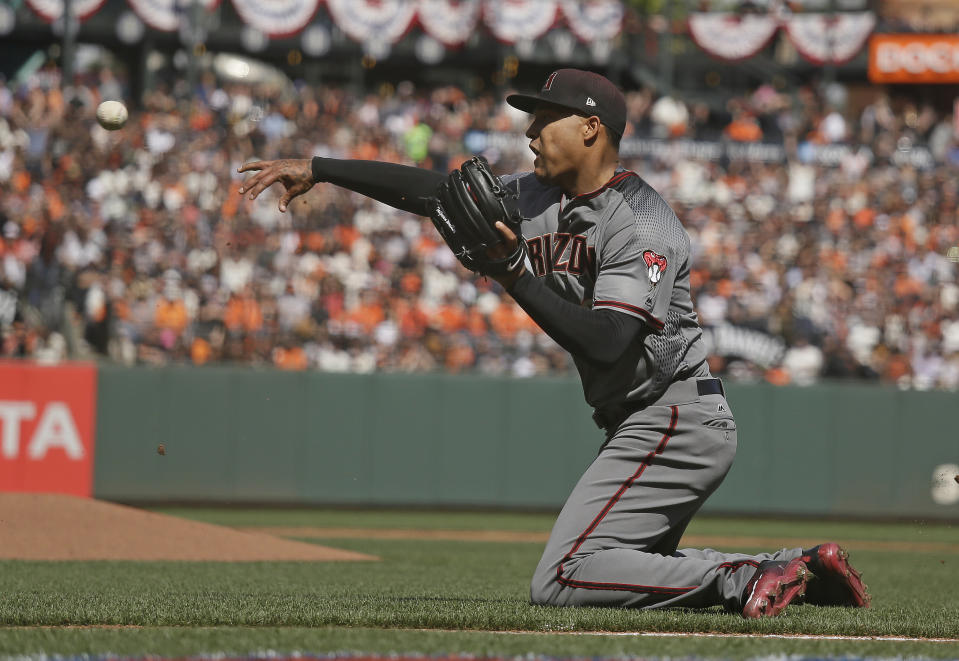 Arizona Diamondbacks starting pitcher Taijuan Walker throws the ball to catcher Jeff Mathis at home plate after the San Francisco Giants' Matt Moore grounded into a fielder's choice in the fourth inning of a baseball game Monday, April 10, 2017, in San Francisco. The Giants' Brandon Crawford scored from third base on the play and Walker was given a throwing error. The Giants scored two other runs following the play and Mathis was given a throwing error. (AP Photo/Eric Risberg)