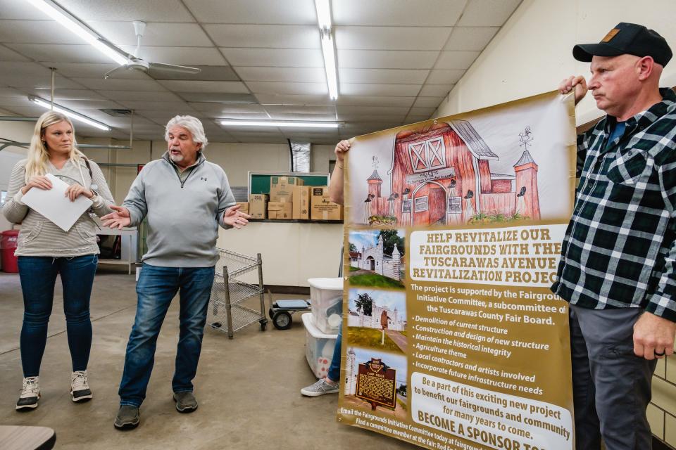 Members of a committee tasked with revitalization of the Tuscarawas County Fairgrounds Tuscarawas Avenue entrance gate talk about proposed plans. Pictured, from left, are Stacy Gordon, Rod Endsley, and Dave McCleary.