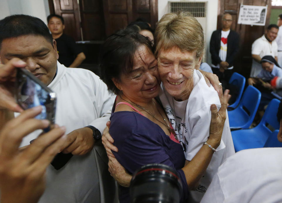 Australian Roman Catholic nun Sister Patricia Fox is hugged by a supporter following a news conference hours before her departure for Australia Saturday, Nov. 3, 2018, in Manila, Philippines. Sister Fox decided to leave after 27 years in the country after the Immigration Bureau denied her application for the extension of her visa. The Philippine immigration bureau has ordered the deportation of Fox who has angered the president by joining anti-government rallies. (AP Photo/Bullit Marquez)