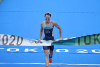 Flora Duffy of Team Bermuda celebrates as she crosses the finish line to win the gold medal during the women's individual triathlon competition at the 2020 Summer Olympics, Tuesday, July 27, 2021, in Tokyo, Japan. (AP Photo/David Goldman)