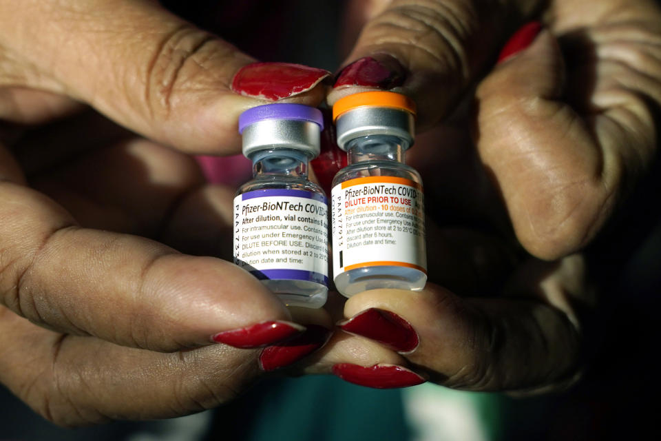 FILE - A nurse holds a vial of the Pfizer COVID-19 vaccine for children ages 5 to 11, right, and a vial of the vaccine for adults, which has a different colored label, at a vaccination station in Jackson, Miss., Tuesday, Feb. 8, 2022. U.S. regulators authorized a COVID-19 booster shot for healthy 5- to 11-year-olds on Tuesday, May 17, 2022, hoping an extra vaccine dose will enhance their protection as infections once again are on the rise. (AP Photo/Rogelio V. Solis, File)