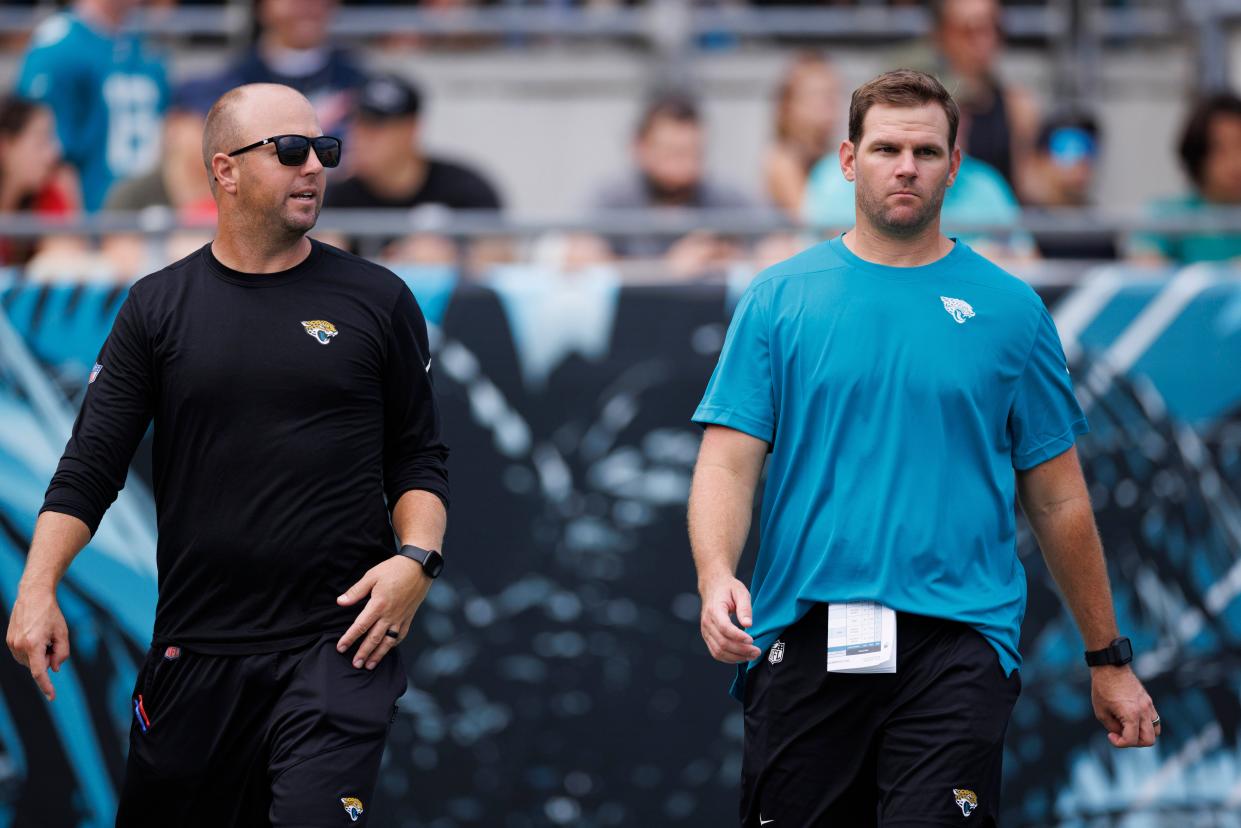 Jaguars passing game coordinator Nick Holz (left) and offensive coordinator Press Taylor (right) walk the stadium as team prepares for scrimmage during training camp on Aug. 5, 2023.