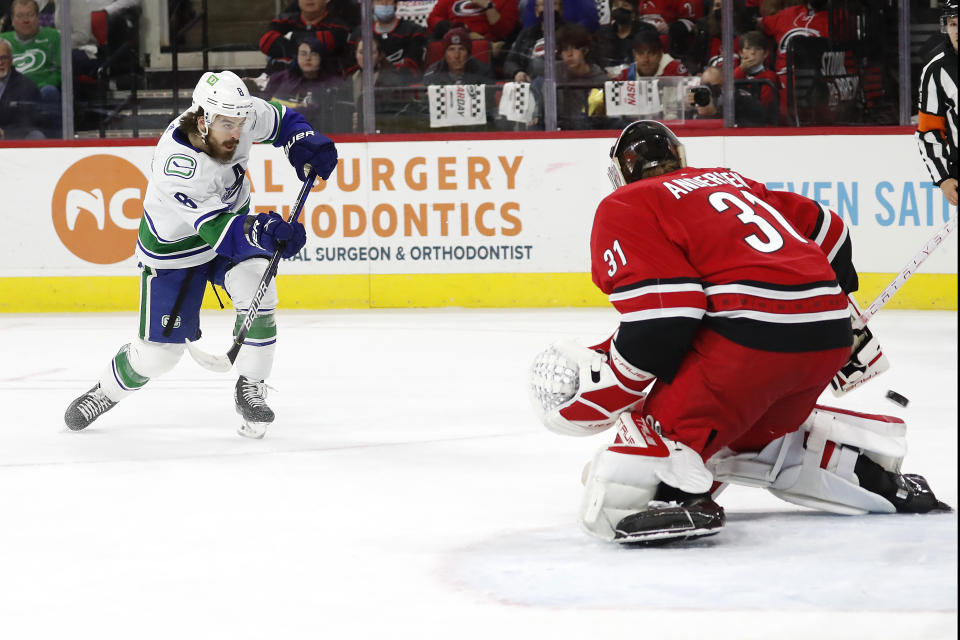 Vancouver Canucks' Conor Garland (8) has his shot bounce off Carolina Hurricanes goaltender Frederik Andersen (31) during the first period of an NHL hockey game in Raleigh, N.C., Saturday, Jan. 15, 2022. (AP Photo/Karl B DeBlaker)