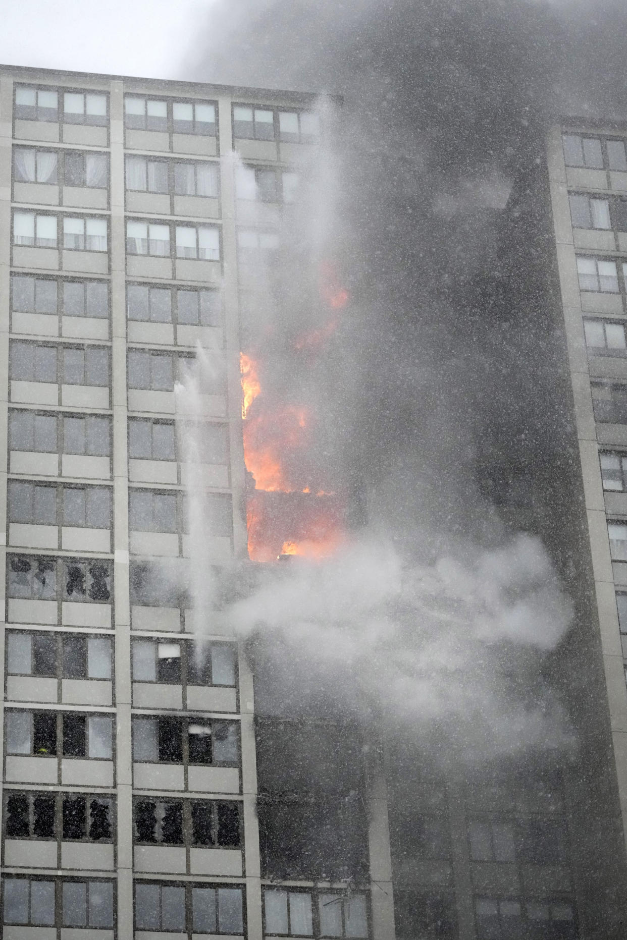 Flames leap skyward out of the Harper Square cooperative residential building in the Kenwood neighborhood of Chicago, Wednesday, Jan. 25, 2023. (AP Photo/Charles Rex Arbogast)